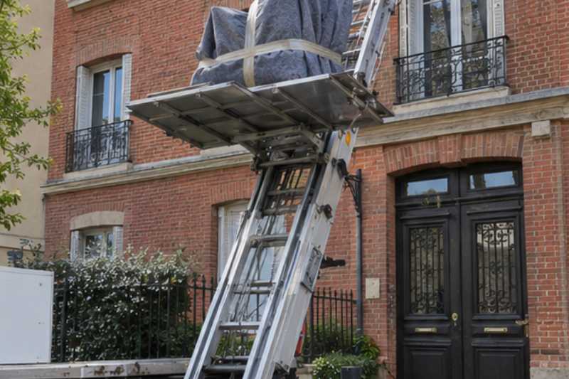 Monte-meuble déployé contre la façade, un fauteuil emballé sur la plateforme, Villemomble